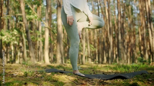 Woman meditates, relaxes and make yoga exercises in the woods alone