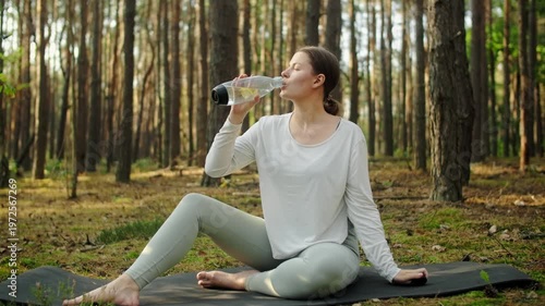 Woman meditates, relaxes and make yoga exercises in the woods alone