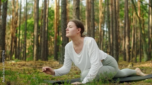 Woman meditates, relaxes and make yoga exercises in the woods alone