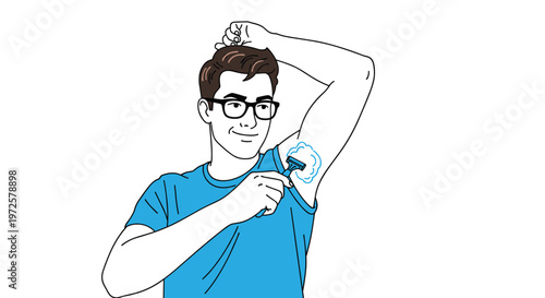 Young man with glasses and a blue shirt carefully shaving his armpit using a razor and white shaving foam for personal grooming.