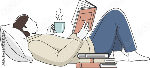 A woman relaxing on a pillow while reading a book and drinking coffee