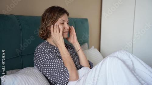 Blonde Mature Woman with Headache Feeling Exhausted and Burned Out in Bedroom