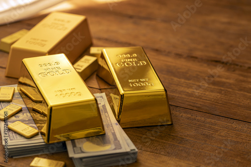 Stacked Gold Bullion Bars and Paper Money on Wooden Surface Representing Financial Wealth and Investment Portfolio