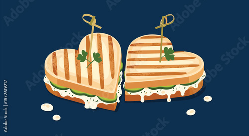 Two heart shaped grilled sandwiches with white sauce and cucumber slices on a dark blue background for romantic meal concepts.