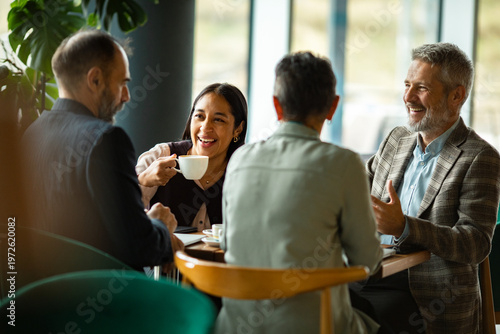 Colleagues having a business coffee meeting in a modern cafe