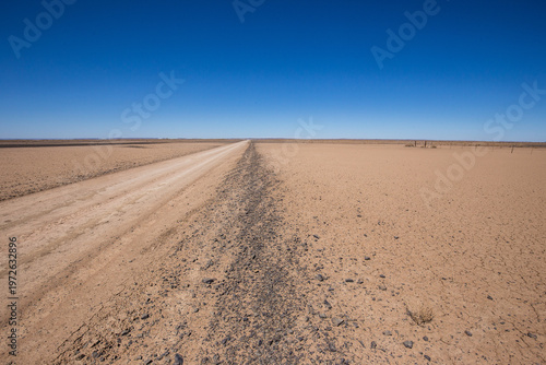 Fotografie Sand road area cutting through the arid and barren Northern Cape landscape en ro