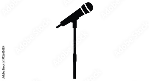 A stark black microphone stands on a slender stand against a white background creating a dramatic silhouette