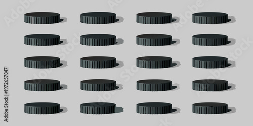 Arrangement of black cylindrical knobs with ribbed edges on a gray surface