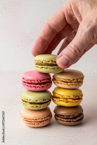 Stack of multi colored macaroons on a light surface 
