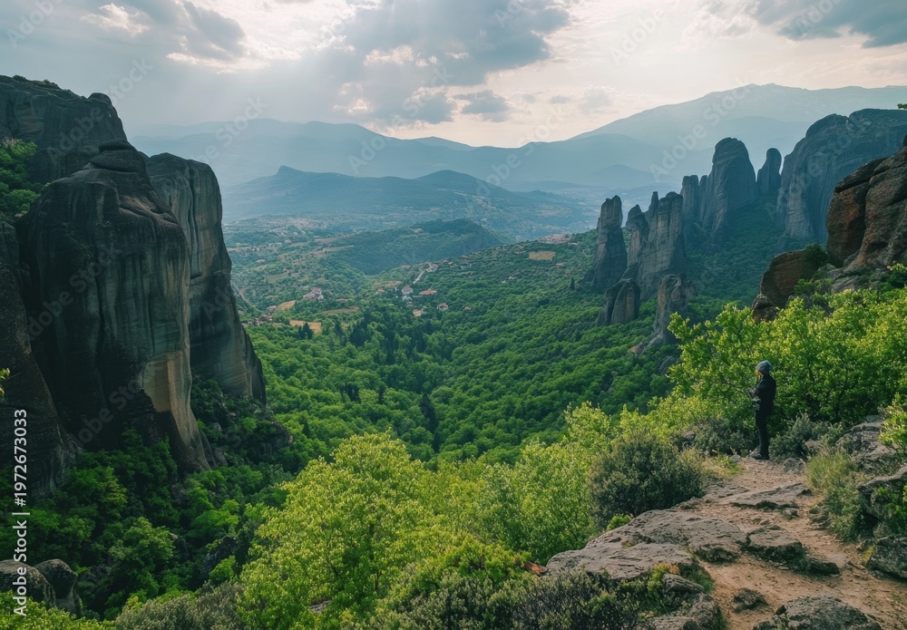 Fototapeta premium Towering Rock Formations Over Lush Mountain Valley