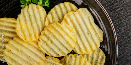 potato chips ribbed fast food tasty snack fresh gourmet food background on the table rustic food top view copy space marketing concept photo