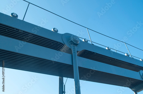 Pinned hanger connection on a steel bridge in blue sky close up
