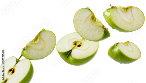 Fotografie Isolated fresh green apple slices and halves floating with seeds, crisp healthy