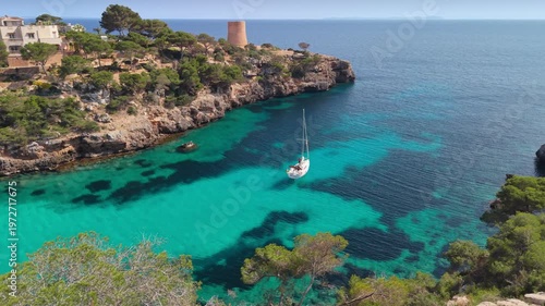 Wallpaper Mural Turquoise water of Cala Pi bay with a white yacht, aerial view of the rocky coast and ancient tower in Mallorca. Paradise bay of Cala Pi with a sailing boat, Mallorca Torontodigital.ca