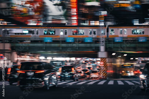 busy traffic at night in Tokyo with intentional camera movement for artistic mood