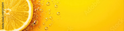 Fresh lemon slice with sparkling bubbles in bright yellow background, vibrant citrus fruit macro image with refreshing and energetic mood