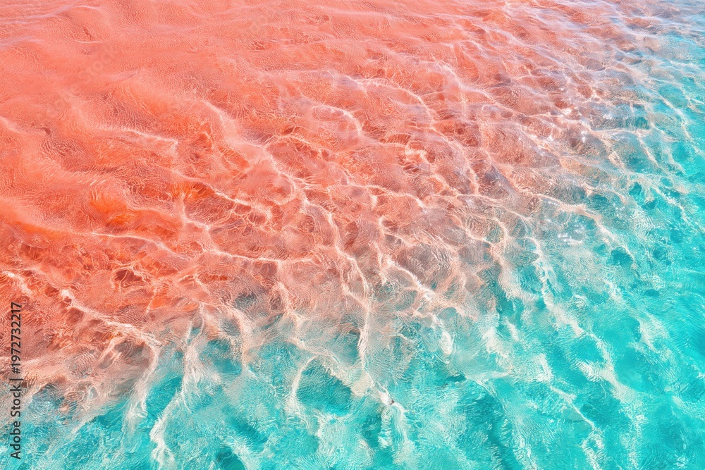 Fototapeta premium Turquoise water meeting pink sand shoreline with visible ripples