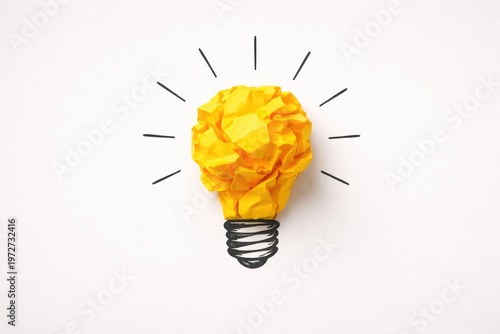 Creative idea concept with crumpled yellow paper light bulb on white background
