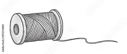 Of a spool of dark gray thread with a loose end sewing needlework craft