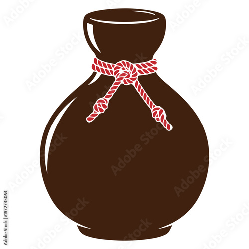 Traditional Japanese sake bottle with red rope decoration.