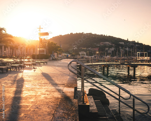 Seaside promenade with loungers in Portorož at sunrise