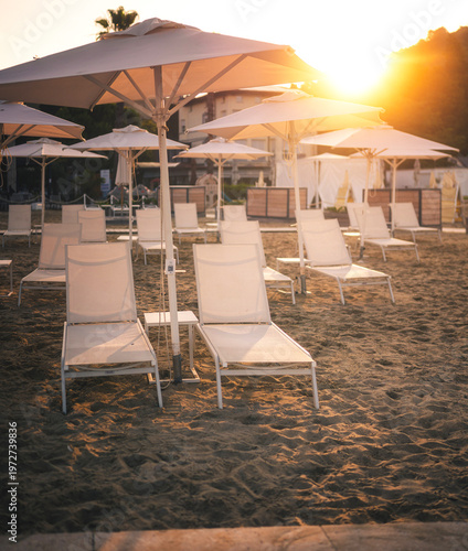 Seaside promenade with loungers in Portorož at sunrise