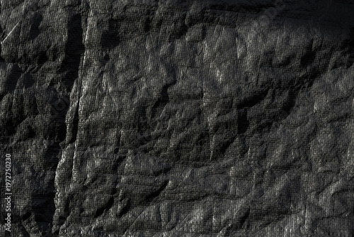 Fotografija Close-up of a thick black outdoor tarp with a rugged, wrinkled surface