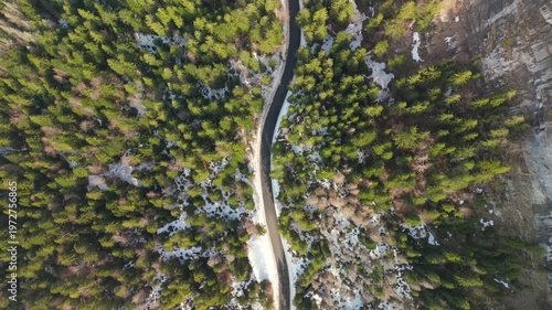Aerial drone flying over winding mountain road in Jura