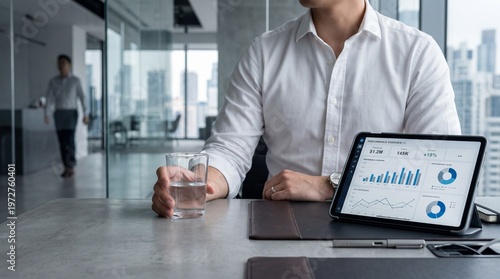 Corporate professional reviewing financial performance metrics on digital tablet