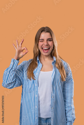 Positive woman forms OK, OKay hand sign, smiling confident. Confirmation,success