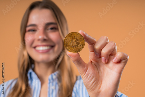 Pretty Woman With Bitcoin, Crypto Currency. Golden Coin On Beige Background.