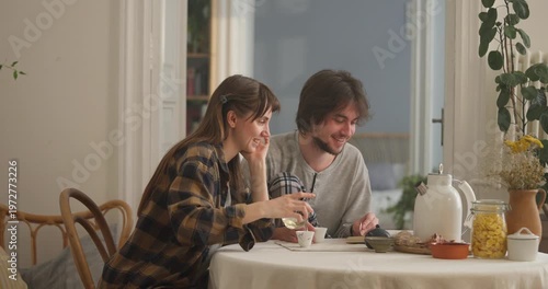 Two friends enjoy tea and lively conversation in a charming kitchen, sharing smiles and good moments filled with joy