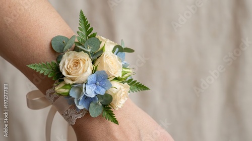 Fresh floral wrist corsage with blue and beige flowers on arm, promo concept   