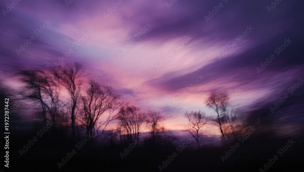 Obraz premium Dramatic Purple Sunset Sky Over Silhouetted Trees.