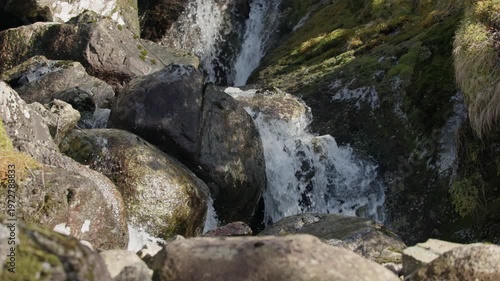 Waterfall Cascading Down Rocky Terrain.