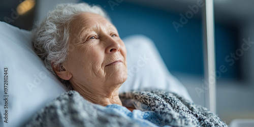 Close-up portrait of a thoughtful elderly woman with white hair lying in a hospital bed, looking away with a peaceful and hopeful expression during her recovery in a modern medical facility