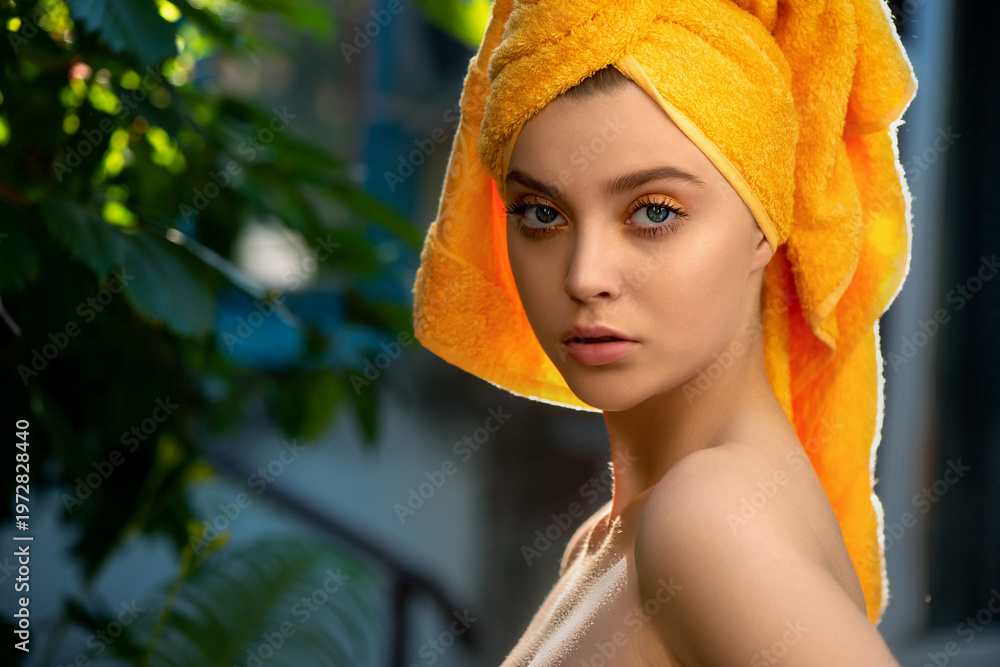 custom made wallpaper toronto digitalBeautiful young woman with perfect skin and yellow towel on the head poses in tropical green leaves background. Luxury beauty model with make-up with tropical leaves. Close-up, selective focus.