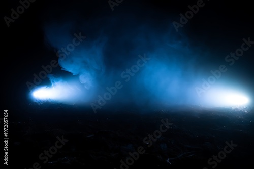 Glowing blue smoke with light in dark atmosphere.