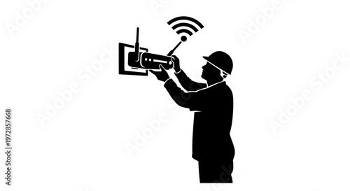 Network Technician Silhouette: A skilled technician, silhouetted against a plain backdrop, meticulously installs a network device, the image symbolizing connectivity and technical expertise.