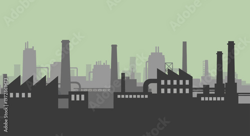 Industrial factory buildings and chimneys silhouette against a green sky.