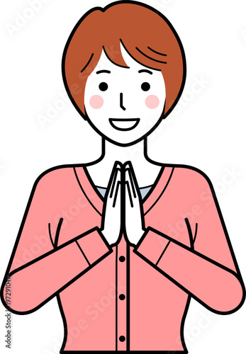 正面向き。いただきますと手を合わせるカーディガンを着た若い女性。