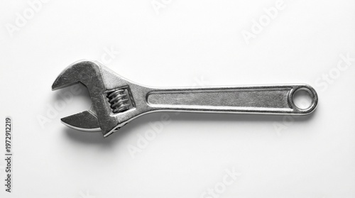 An adjustable wrench, also known as a monkey wrench, is a versatile tool for tightening and loosening nuts and bolts of various sizes, commonly found in toolboxes for DIY and professional use