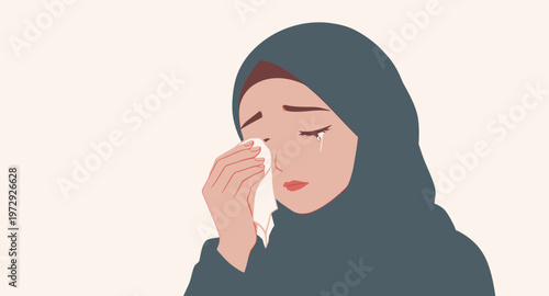 Woman crying and blowing her nose.