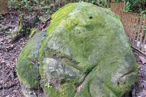 Rock carvings of human figures carved into sandstone boulders located at Santubong Archaeological Park in Kuching, Malaysia.