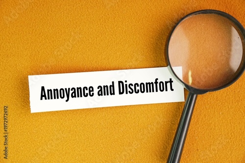 Принти на полотні A magnifying glass and paper with the words Annoyance and Discomfort