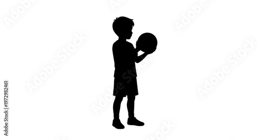 Black silhouette of a little boy standing and holding a ball isolated on white background

