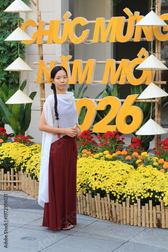 Model standing in front of a Vietnamese Happy New Year sign for TET. 
