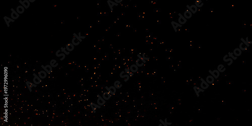 Blur, bokeh, fire, red light, tiny specks created by the heat energy of burning fuel on a black background.