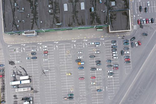 shopping mall parking lot with parked cars. aerial top view from flying drone.