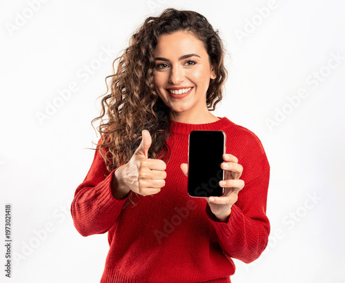 Woman giving thumbs up with smartphone.